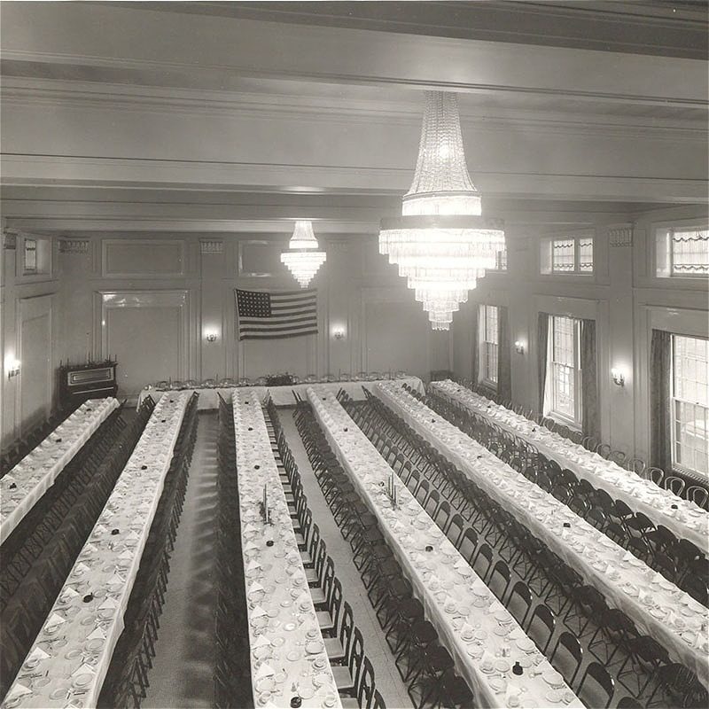 Banquet hall with long tables and chandeliers