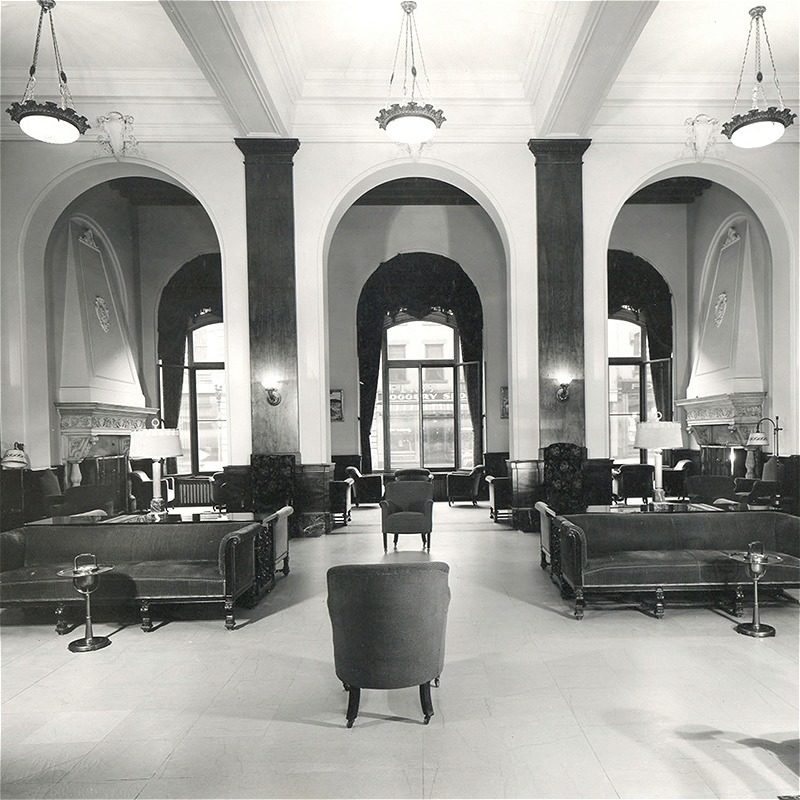Elegant hotel lobby with vintage seating and large windows