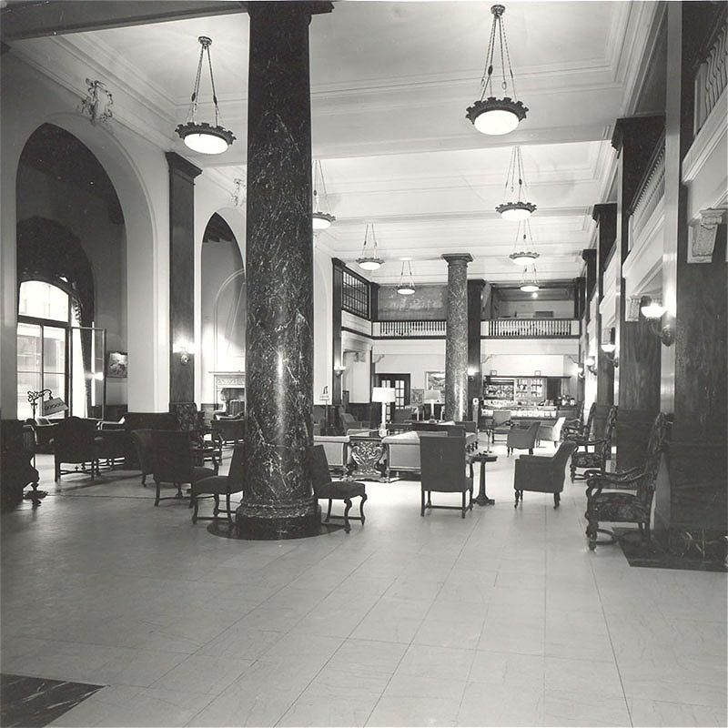 Elegant hotel lobby with marble columns and vintage seating
